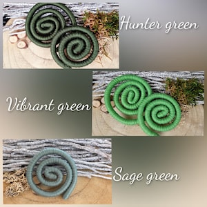 May include: Three sets of coiled rope decorations in varying shades of green. The top set is labeled Hunter green, the middle set is labeled Vibrant green, and the bottom single coil is labeled Sage green. Each coil is made of wrapped cord.