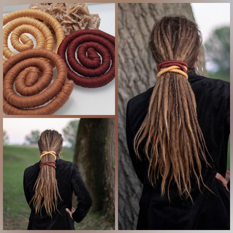 May include: Three flexible, fabric-wrapped spiral hair ties in mustard yellow, light brown, and deep burgundy. These long, cylindrical accessories are shown coiled individually and wrapped around a thick ponytail of long, light brown dreadlocks.