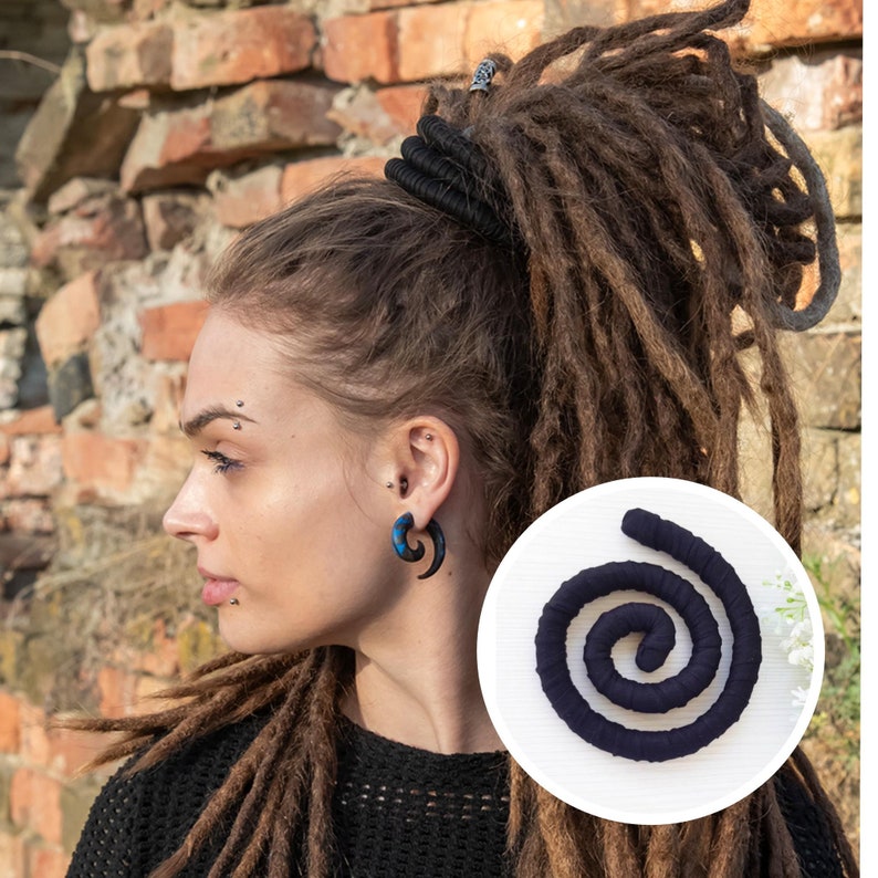 May include: A black fabric-wrapped spiral hair accessory shown in a circular inset, featuring a flexible, coiled design. The accessory is designed to be wrapped around dreadlocks or thick hair, providing a secure hold with its dark, matte texture.