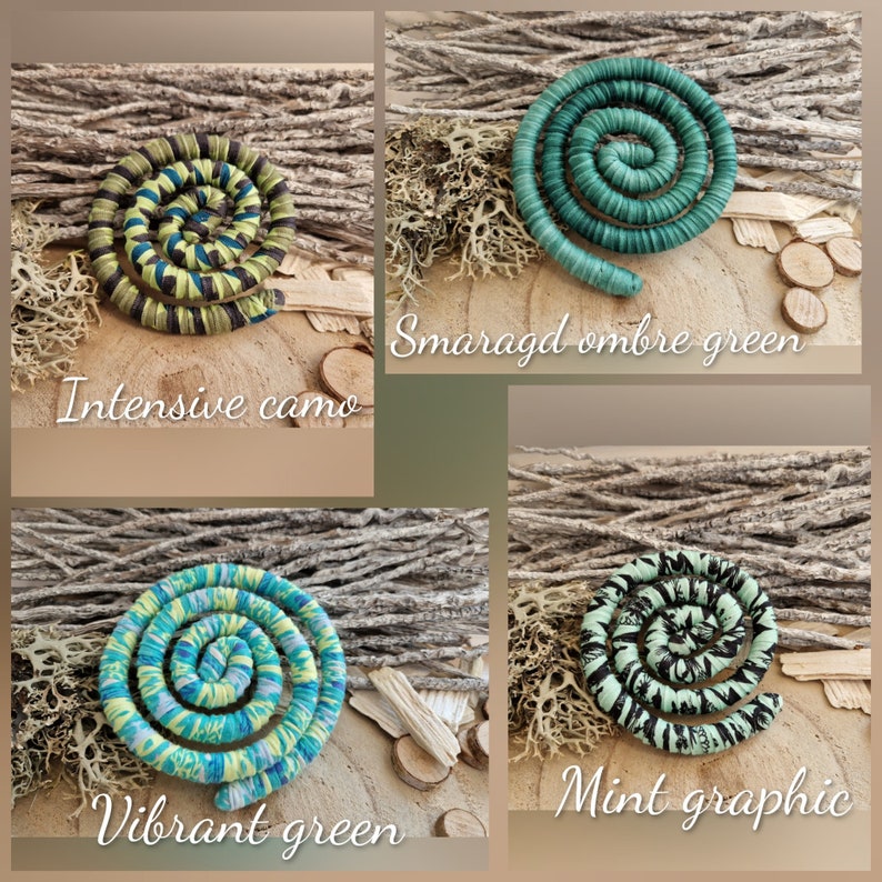 May include: Four spiral-shaped fabric ornaments featuring distinct patterns: Intensive camo in olive and black, Smaragd ombre green in solid teal, Vibrant green with blue and yellow swirls, and Mint graphic with black and mint green abstract markings.