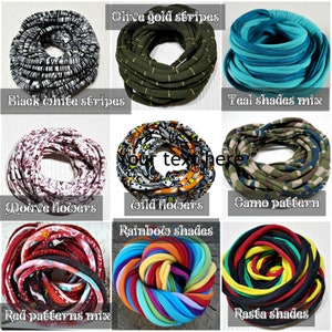 May include: A collection of nine circular fabric headbands displayed in a grid. The designs include black and white stripes, olive gold stripes, teal shades, mauve flowers, wild flowers, camo pattern, red patterns mix, rainbow shades, and rasta shades.
