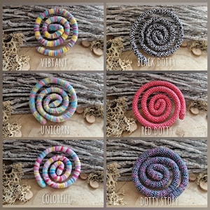 May include: Six spiral-shaped decorative items in various colors, including vibrant, black and white, red, and blue. Each spiral has a unique pattern and is labeled with a descriptive word such as "Vibrant" or "Dotty Story".