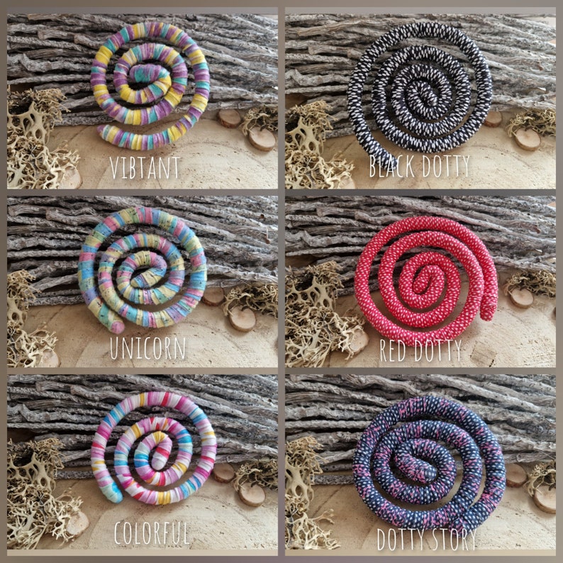 May include: Six spiral-shaped decorative items in various colors, including vibrant, black and white, red, and blue. Each spiral has a unique pattern and is labeled with a descriptive word such as "Vibrant" or "Dotty Story".