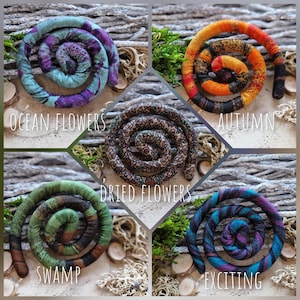 May include: Five spiral-shaped fabric hair accessories in various colors and patterns. The Ocean Flowers style is teal and purple, Autumn is orange and black, Dried Flowers is brown with floral prints, Swamp is green and brown, and Exciting is blue and purple.