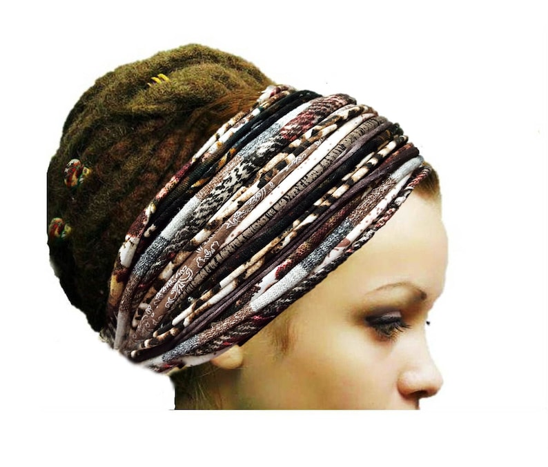 May include: A wide, multi-layered fabric headband featuring a variety of brown, black, white, and grey patterns, including animal prints and paisley designs. The accessory is constructed from several thin, twisted fabric strips wrapped together.