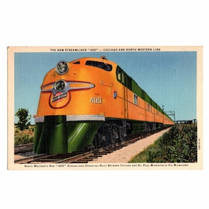 May include: Vintage postcard featuring the "400" Streamliner train, operated by the Chicago and North Western Line. The train is painted in orange and green, with the words "The 400" visible on the front. The postcard includes text about the train's route.