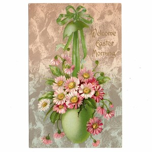 May include: Vintage Easter postcard featuring a green vase overflowing with pink and white daisies. A green ribbon and the words "Welcome Easter Morning" are at the top. The background has a textured, neutral color.