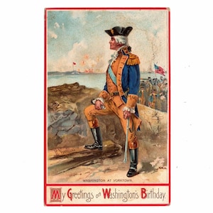 May include: Vintage postcard featuring a color illustration of George Washington in a military uniform, standing on a rocky outcrop overlooking a battle scene. The text at the bottom reads "My Greetings on Washington's Birthday."