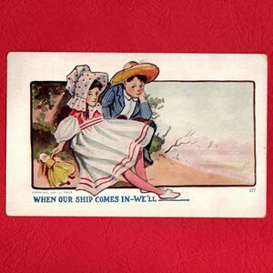 May include: Vintage postcard featuring a color illustration of two children. A girl in a white dress with red trim and a bonnet holds a doll. A boy in a blue jacket and straw hat sits beside her. The text reads "WHEN OUR SHIP COMES IN-WE'LL".