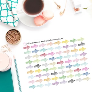 May include: A sheet of colourful hand-drawn arrow stickers. The arrows are in various colours, including red, blue, green, yellow, and purple. The stickers are perfect for adding a touch of personality to planners, journals, and other paper goods.