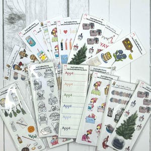 May include: A collection of planner stickers featuring various designs, including a flamingo, a Christmas tree, a book stack, a potted plant, and a cake. The stickers are packaged in clear plastic bags and labeled with the website "Simple Southern Mommy".