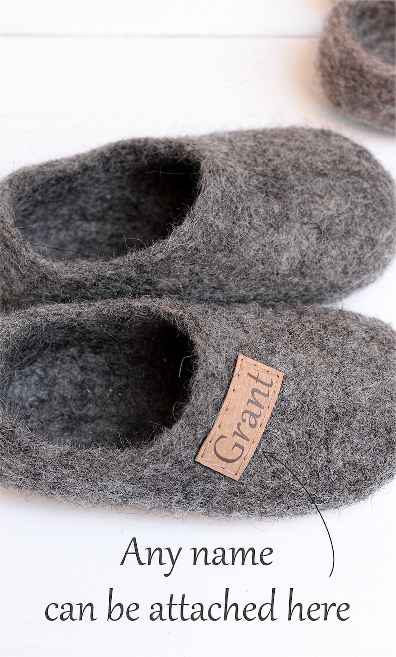 May include: A pair of grey wool slippers with a brown leather label that says "Grant". Any name can be attached here.