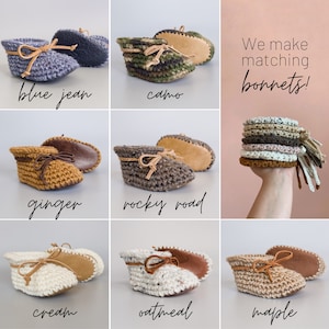 May include: Crocheted baby booties in various colors, including blue jean, camo, ginger, rocky road, cream, oatmeal, and maple. The booties have leather soles and are tied with a leather ribbon. The text "We make matching bonnets!" is visible in the image.