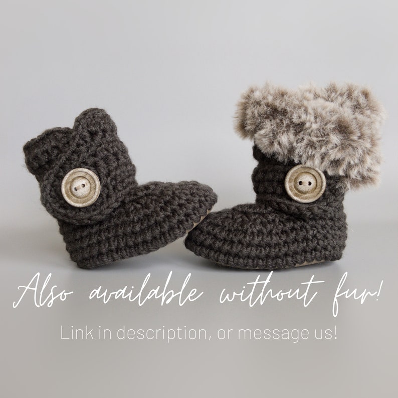 May include: A pair of dark gray crochet baby boots. One boot features a faux fur trim and both have a large button closure. The text "Also available without fur!" is visible. The boots are designed for infants.