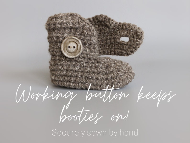 May include: Brown crocheted baby booties with a button closure. The text "Working button keeps booties on! Securely sewn by hand" is below the booties.