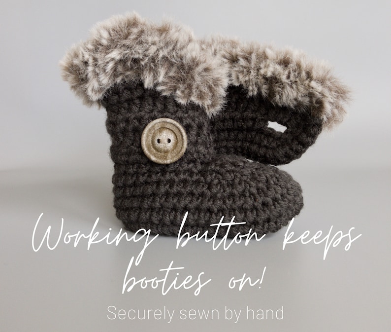 May include: A dark gray crocheted baby bootie with a faux fur trim. A large, round, tan button secures the bootie. The text "Working button keeps booties on!" is visible.