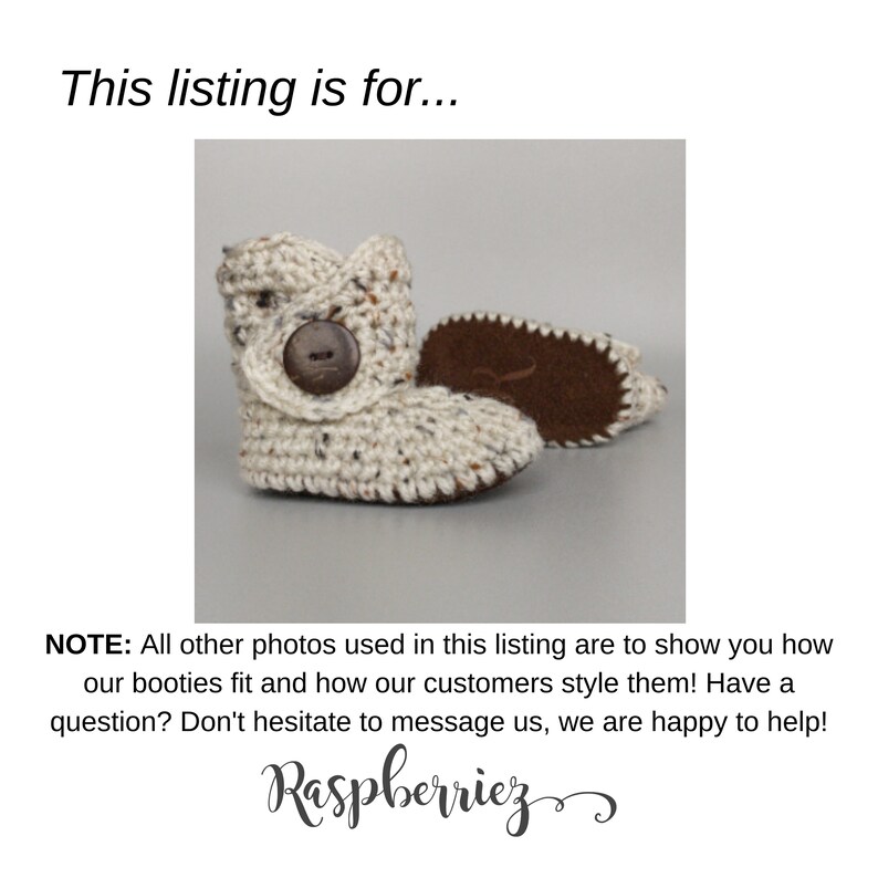 May include: A pair of cream-colored crocheted baby booties with brown button accents. The booties have a suede sole.