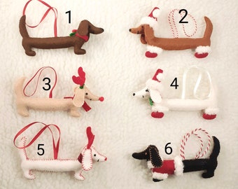 May include: Ten felt dachshund ornaments in various colors and designs, including red, white, and black. Each ornament has a loop for hanging and is numbered 1 through 10.