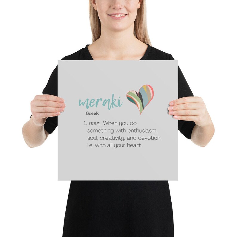 May include: A gray poster with the word "meraki" in blue text and the definition of the word in black text. The word "meraki" is in a stylized font and is accompanied by a colorful heart graphic.