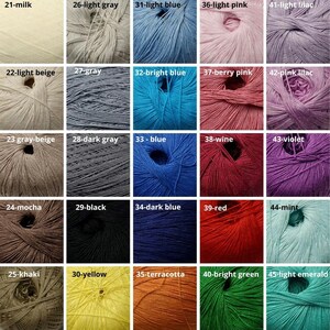 May include: A color chart of yarn skeins in various shades, including milk, light gray, light blue, light pink, and light lilac. Other colors include gray-beige, dark gray, blue, wine, and violet. Additional colors are khaki, yellow, terracotta, bright green, and light emerald.