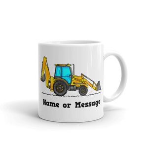 May include: White ceramic mug with a yellow cartoon excavator illustration. The mug has a black handle and the text "Name or Message" printed on the bottom.