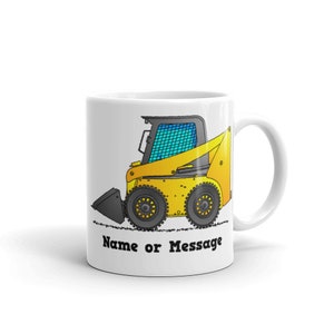 May include: White ceramic mug with a cartoon illustration of a yellow skid steer loader. The mug has the text "Name or Message" printed on the bottom.