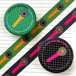 May include: Washi tape rolls and strips with a repeating pattern of a pink and orange tool design on a black and green grid background. The rolls have text that reads "coco west illustration". The tape is 15mm x 10m.