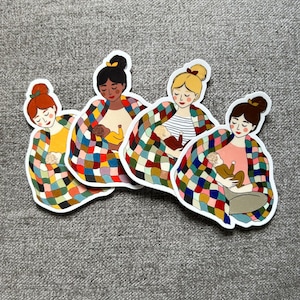 May include: Four stickers featuring illustrations of women breastfeeding babies. Each woman is wrapped in a colorful patchwork quilt. The women have different skin tones and hair colors, and the babies are in various positions.
