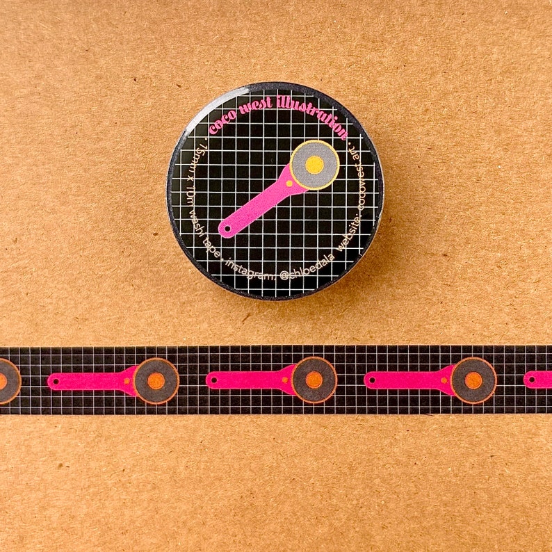 May include: A black and white round button and washi tape featuring a pink rotary cutter design. The button has the text "coco west illustration" and social media handles. The washi tape has a repeating pattern of the same cutter design.