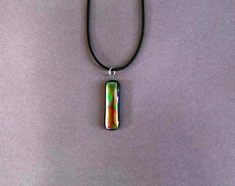 Rainbow swirl, thin fused dichroic glass pendant with embedded wire hook with jump ring on 18" black rubber cord with plug in clasp.