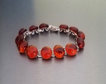 Glass nugget link bracelet of dark amber glass nuggets on silver plated link bracelet finding with sturdy clasp.