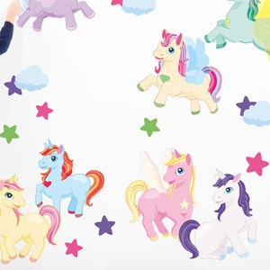 May include: A set of colorful unicorn wall decals with stars and clouds. The decals are perfect for adding a whimsical touch to a child's room.