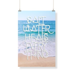 May include: A poster with a blue and white ocean scene and the text "Salt Water Heals Everything" in white.