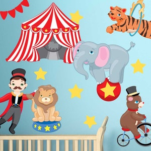 May include: A set of colorful circus-themed wall decals featuring a red and white striped tent, a gray elephant balancing on a red ball with a yellow star, a brown bear riding a red and black bicycle, a brown lion sitting on a blue and white pedestal, a ringmaster in a red and black suit, and a yellow tiger jumping through a yellow hoop.