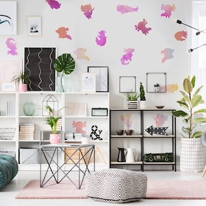 May include: A bright, airy room with white shelving units, a pink rug, and a geometric patterned ottoman. Watercolor axolotl wall decals in shades of pink, orange, and purple decorate the wall. Decorative items and plants are displayed.