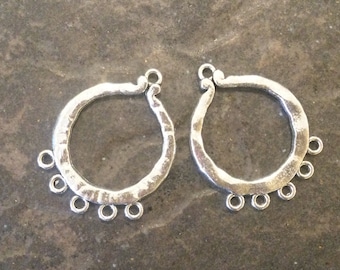 May include: Two silver-toned metal hoops with a hammered finish. Each hoop has five small loops hanging from the bottom.