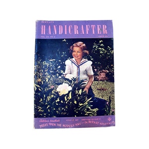 May include: Vintage Bernat's Handicrafter magazine cover. The cover features a young girl in a sailor-style knit top and dark pants, surrounded by flowers. The magazine title is in purple with the text "HANDICRAFTER". The cover also includes the text "Children's handknits".