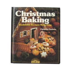 May include: A cookbook titled "Christmas Baking" with the subtitle "Traditional Recipes Made Easy" by Christian Teubner. The cover features a gingerbread house and various Christmas cookies.