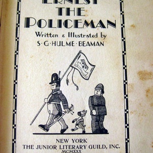 May include: Vintage book cover for "Ernest the Policeman" by S.G. Hulme Beaman. The cover features a black and white illustration of a policeman, a dog, and another figure. The title is in bold, stylized lettering, with the publisher's information at the bottom.