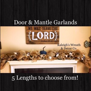 May include: A decorative garland made of tan mesh fabric, featuring small white cotton bolls and a single dark blue pumpkin. The garland is displayed on a white mantle below a wooden sign that reads WE WILL SERVE THE LORD Joshua 24:15.
