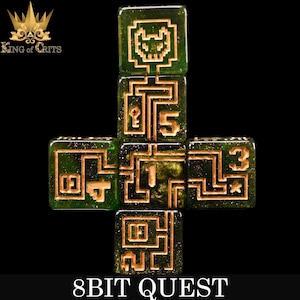 May include: A set of six green dice with gold glitter and gold-colored 8-bit inspired designs. The dice are arranged in a cross shape. The numbers 1, 2, 3, 4, 5, and a pixelated skull are visible. The dice are labeled "8BIT QUEST".