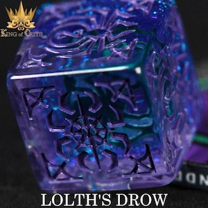 May include: A purple and blue iridescent dice with a spiderweb design and the text "Lolth's Drow" on the bottom.