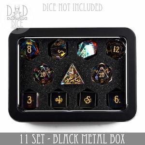May include: A black metal box with a foam insert to hold 11 iridescent dice. The dice are in various shapes and sizes, with gold numbers. The box has the text "D&D Dice" and "Dice Not Included" printed on it. The box is labelled "11 Set - Black Metal Box".