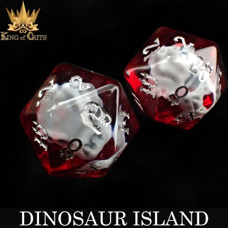May include: Two red and clear dice with white dinosaur skull designs. The dice are numbered 1 through 6.