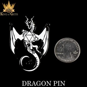 May include: Black and white enamel pin of a dragon holding a 20-sided die. The pin is about the size of a US quarter.