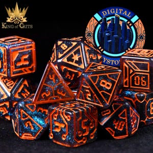 May include: A set of polyhedral dice featuring an orange and black circuit board design. The dice have a glittery blue interior and are arranged in a pile. A circular emblem with the text "DIGITAL CYSTOMS" is also visible.