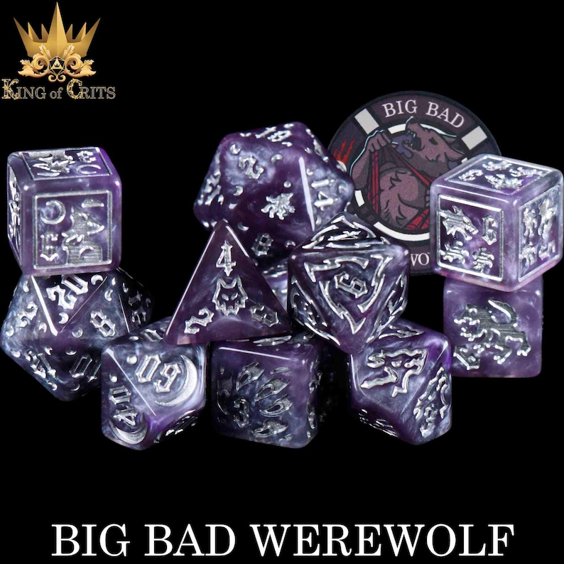 May include: A set of purple and silver dice with the text "BIG BAD WEREWOLF". The dice have a marbled effect and silver numbering and symbols. A circular token with a werewolf graphic is also present.