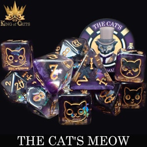 May include: A set of eight purple and gold iridescent dice with cat faces and the text "The Cat's Meow" on the bottom of the dice.