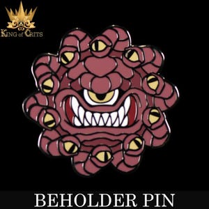 May include: A red and gold enamel pin depicting a beholder, a creature from Dungeons & Dragons. The beholder has a large central eye and many smaller eyes around its body. The pin is a collectible for fans of fantasy and role-playing games.