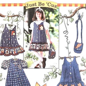 May include: Simplicity sewing pattern number 7015 for sizes AA, 3, 4, 5, and 6. The pattern includes instructions for making three different dresses and a small purse. The dresses are all blue and white with a patchwork design. The purse is blue with a red heart and a carrot design. The pattern is titled "Just Be 'Cuz".